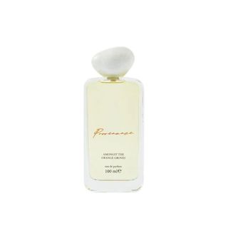 A light yellow clear perfume 100ml bottle with a white shapely cap. 