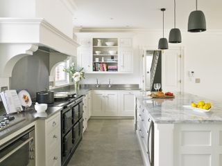 White kitchen with stainless steel countertop and island with quartzite countertop