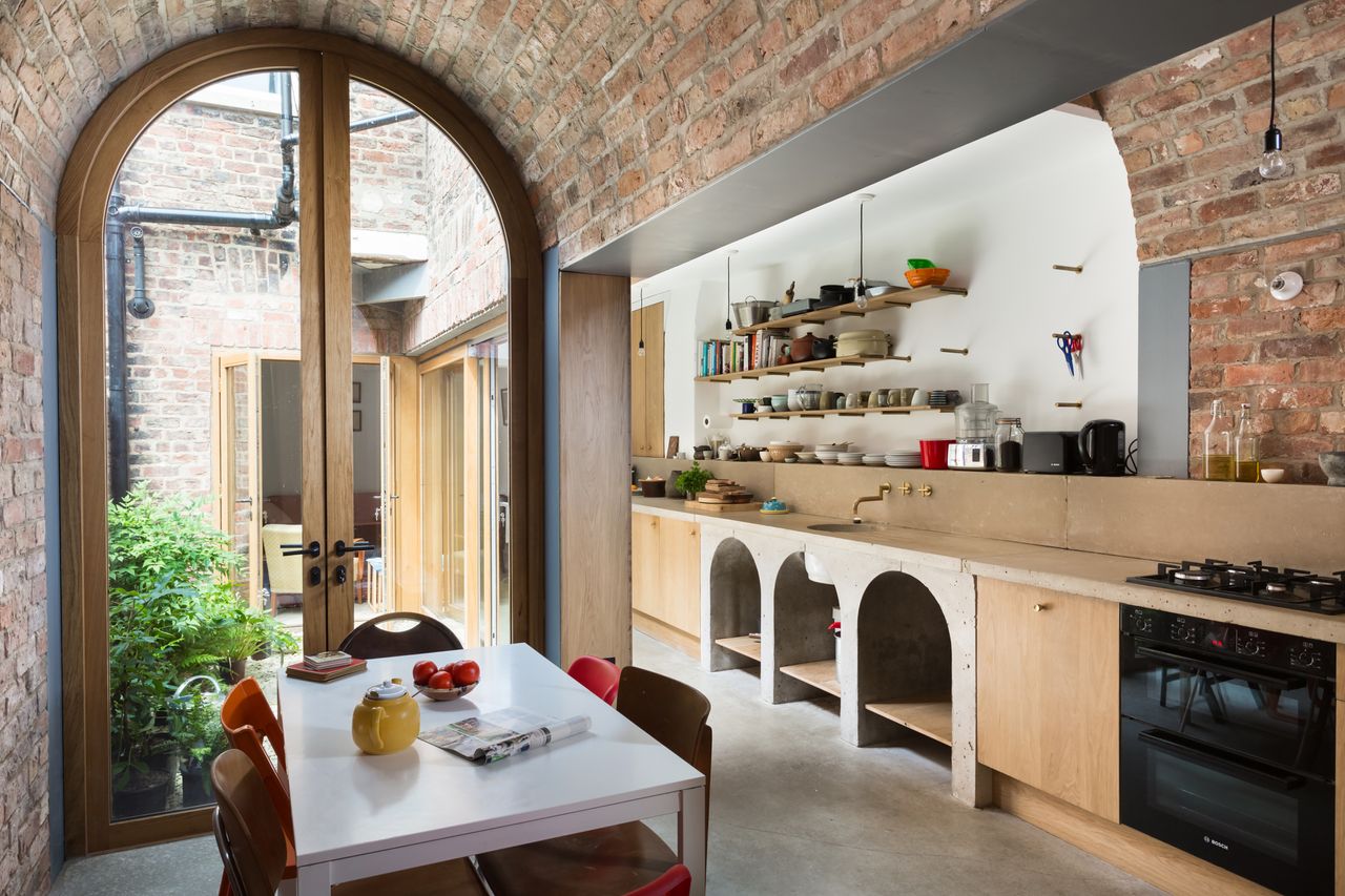 open plan kitchen with barren vaulted ceiling
