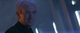Tomorrow Never Dies Jonathan Pryce as Elliot Carver, smirking in the stealth ship