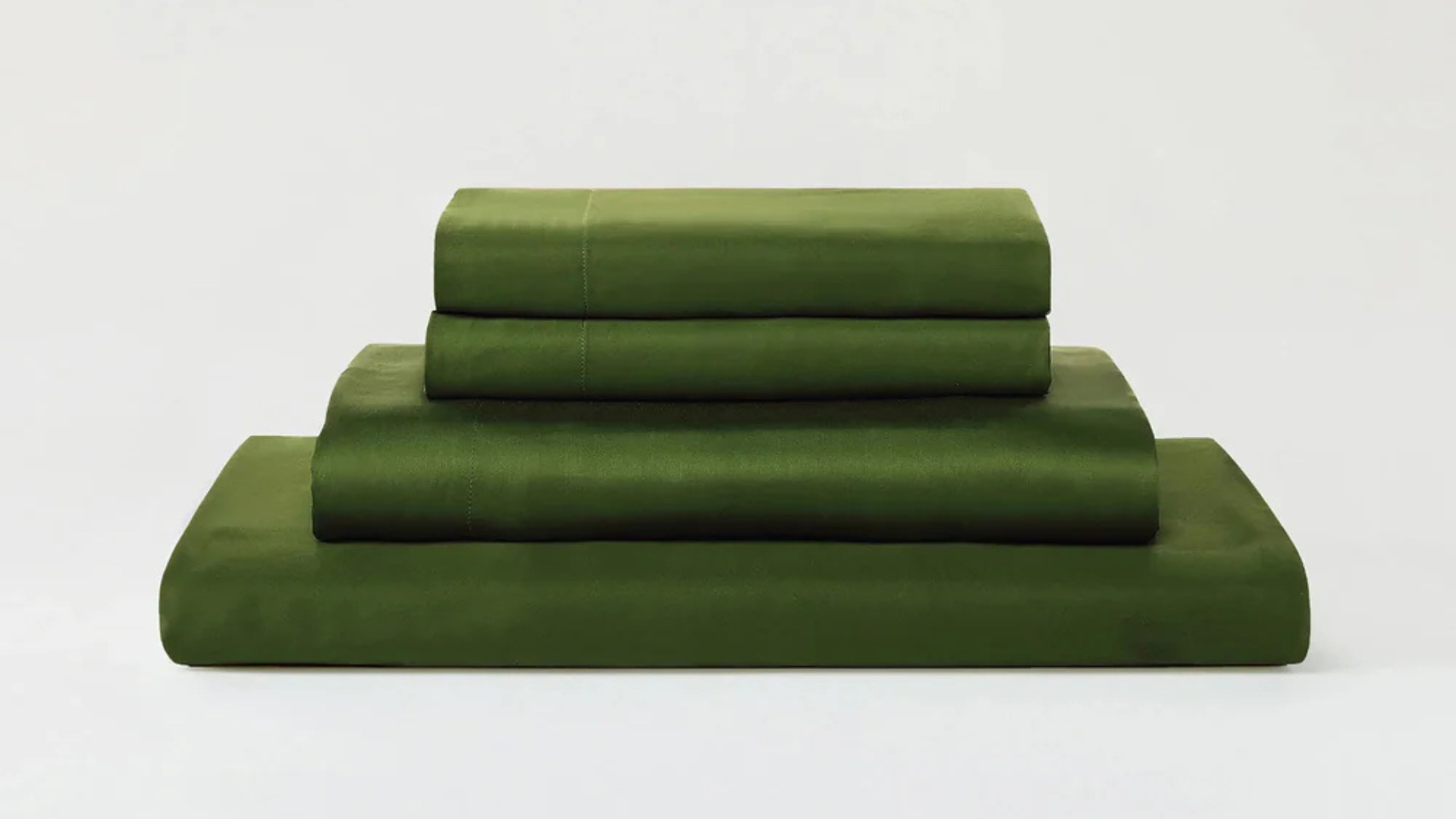 Sijo Airyweight Eucalyptus sheet set in green stacked and folded against a neutral background