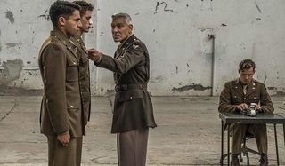 Catch-22 George Clooney lecturing two young soldiers in an open room