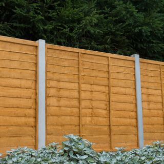 traditional lap fence panels with concrete posts