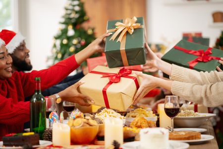 A family is happily exchanging gifts at Christmas