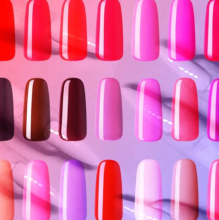 three rows of press-on nails in pink, red, and burgundy on a pink and purple background