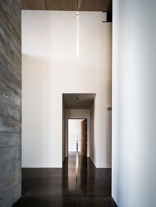 The interior is highly minimalist, a combination of glass, plaster and board-formed concrete