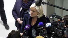 Marine Le Pen talks to the press outside court in Paris