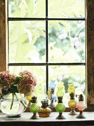 miniature oil lamps in 17th-century cottage window