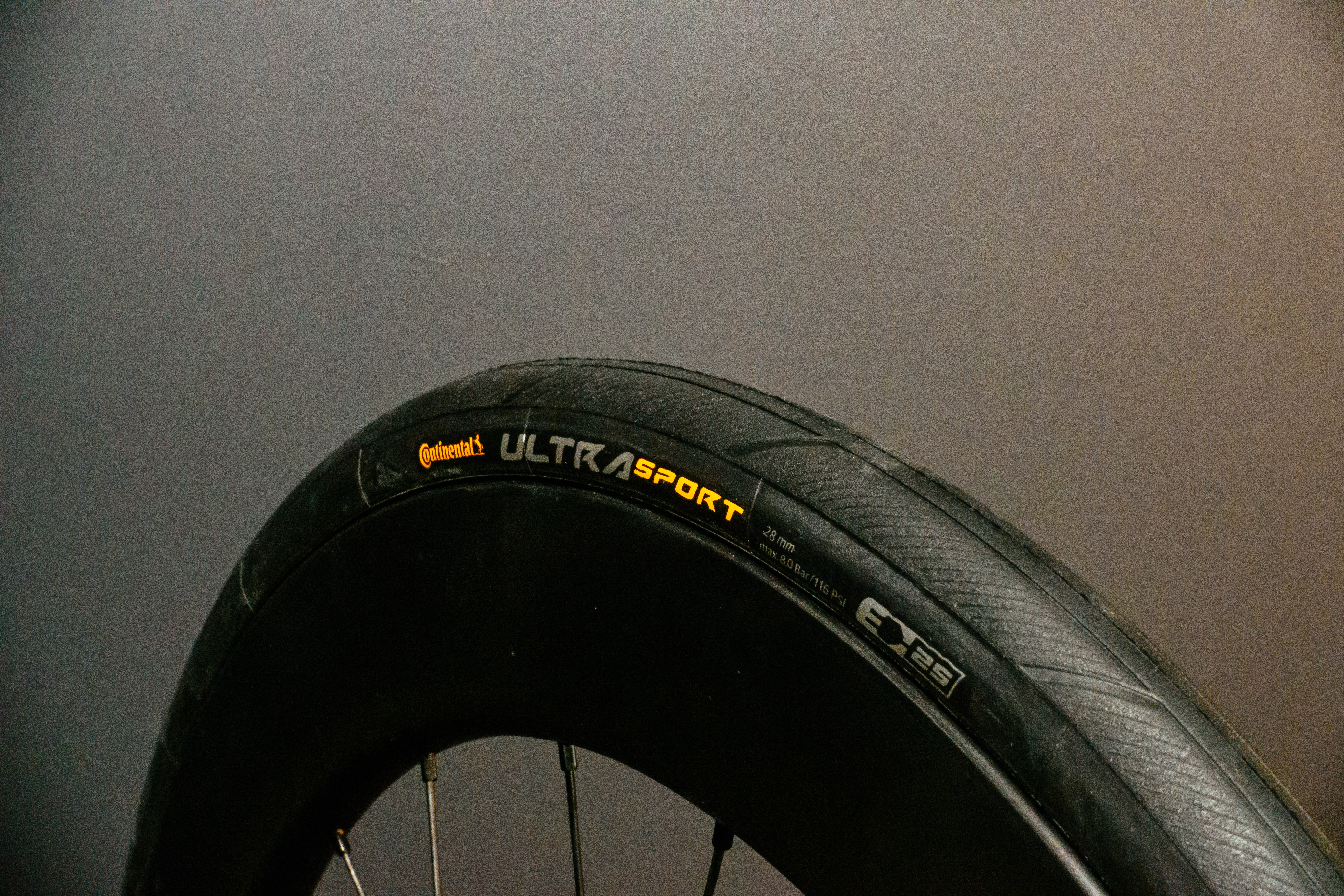 Continental Ultra Sport III Road tyre with a orange background