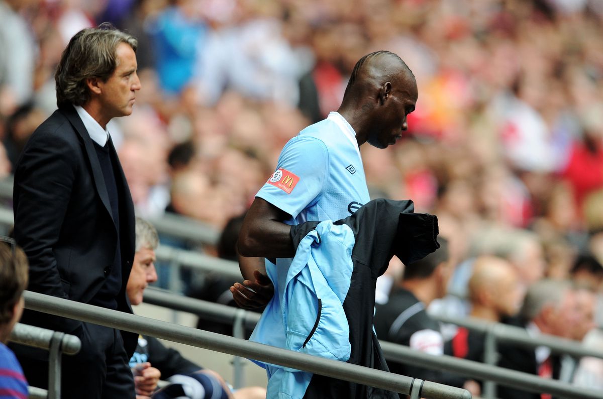 Mario Balotelli of Manchester City walks away from manager Roberto Mancini after being substituted off during the 2011 Community Shield against Manchester United at Wembley