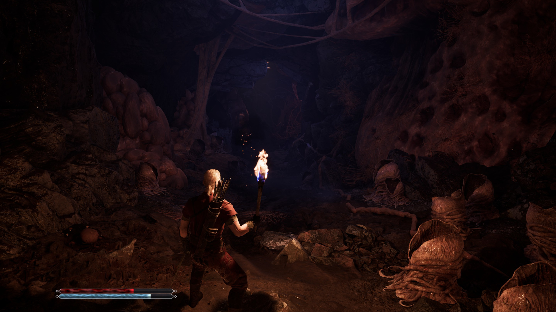 The player stands in a very dark cave in Gothic 1 Remake, lit only by their flickering torch