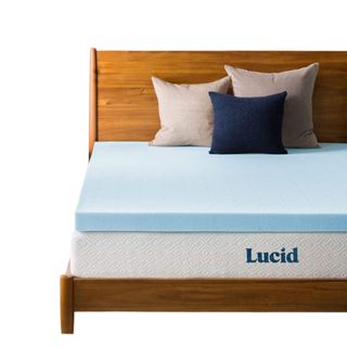 A blue Lucid mattress topper on a wooden bed