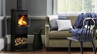 renovated living room with corner log burning stove and sofa
