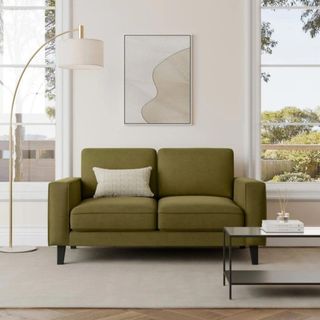Green sofa in a neutral living room