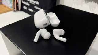 Apple AirPods Pro 2 out of their case on a speaker