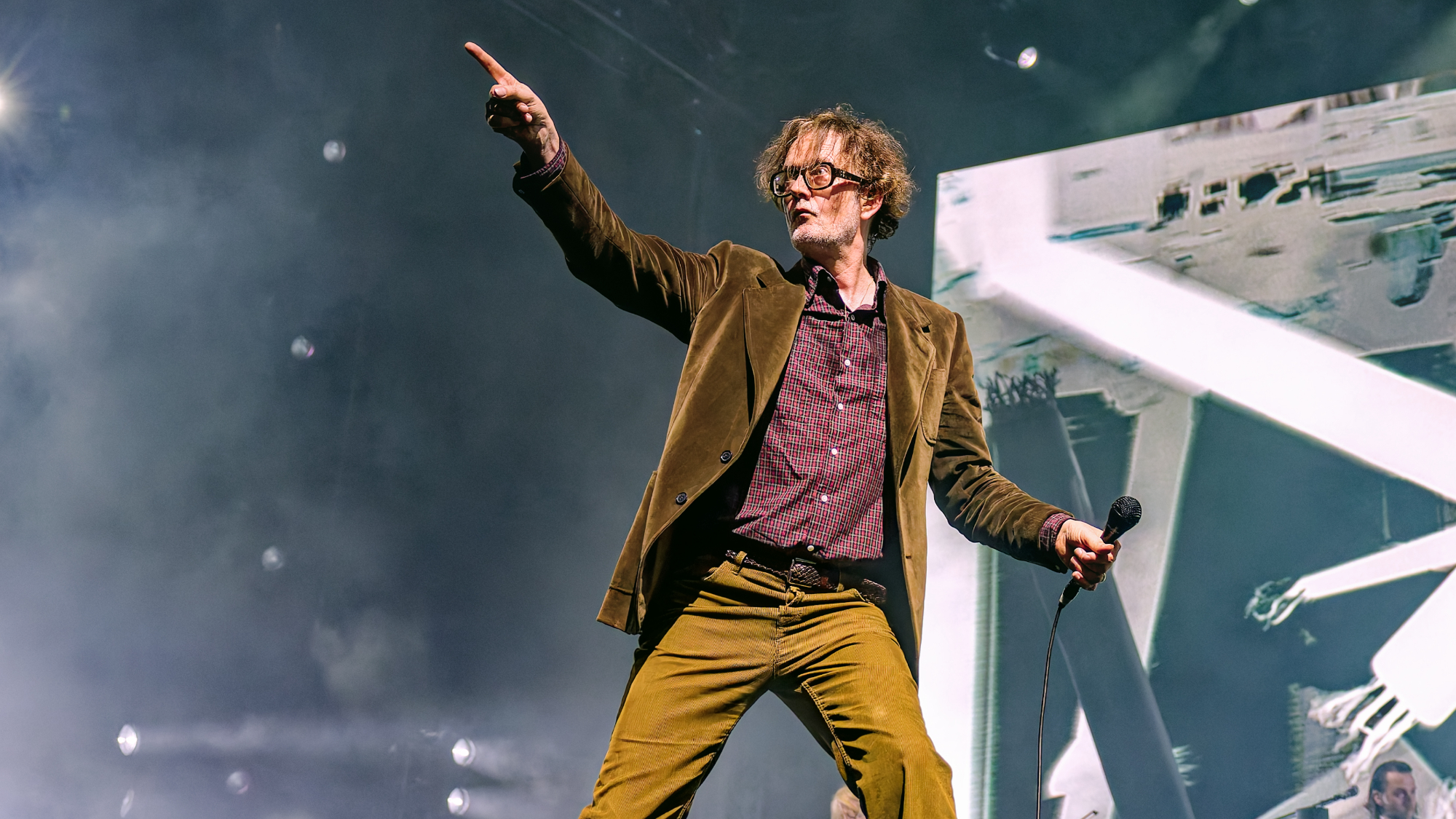 Jarvis Cocker pointing while performing
