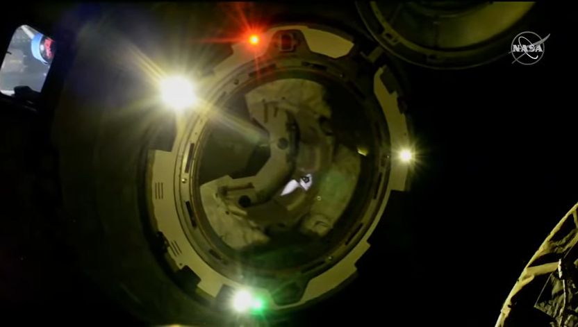 Photo of Boeing's Starliner OFT-2 spaceraft undocking from the International Space Station at night.