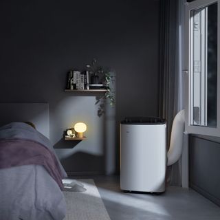 White portable air conditioner in dark grey bedroom