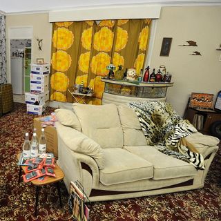 living area with curtains and sofa and calculator