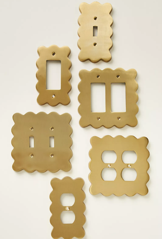 six gold wavy-edged switch plate covers