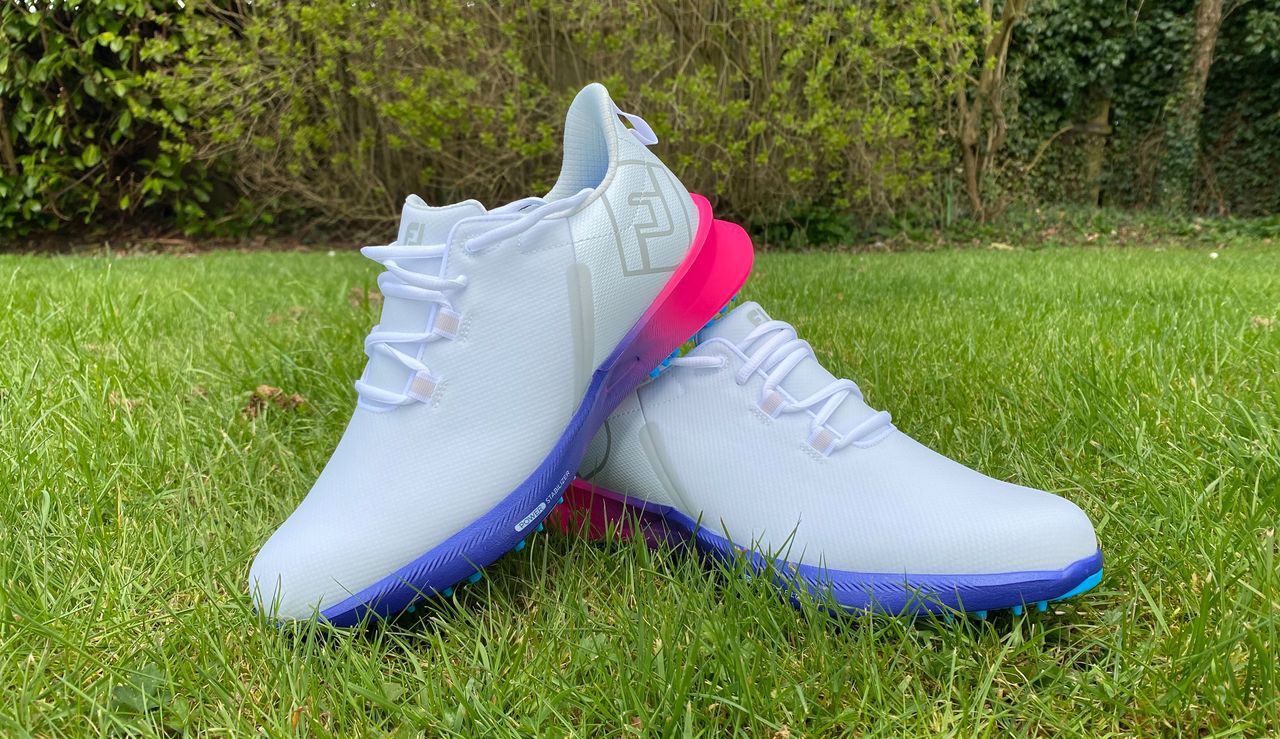 A pair of FootJoy Fuel Sport Golf Shoes on a green background