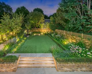outdoor lighting ideas in a garden with uplit trees and steps