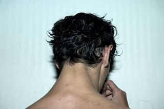 back of male model hair with dark rumpled hair