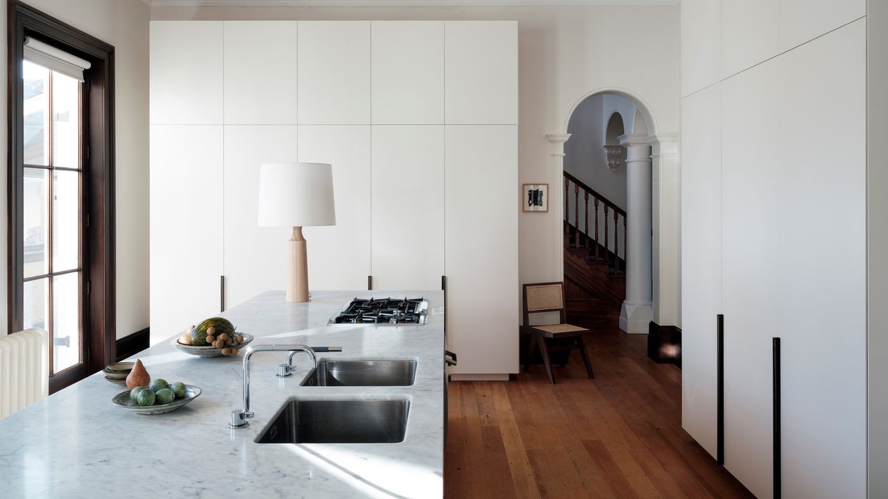 A kitchen island lit with a table lamp