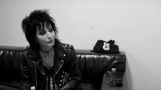 Joan Jett in a leather jacket beingin interviewed in Bad Reputation