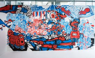 A multi-coloured (red, white and blue) graffiti street art that displays a neighbourhood .