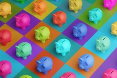 An array of piggy banks in saturated colors on a high color contrast background.