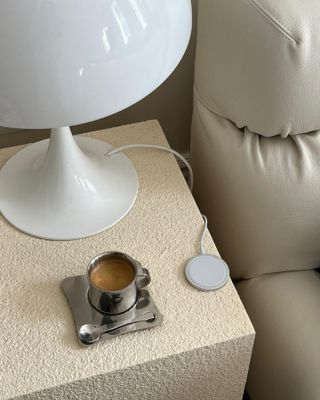 Side table with coffee and lamp