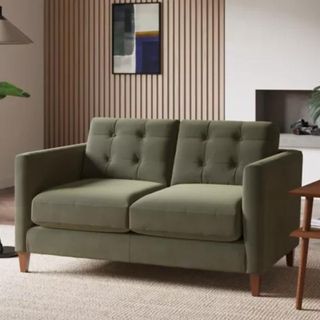 A sage green sofa in a neutral living room