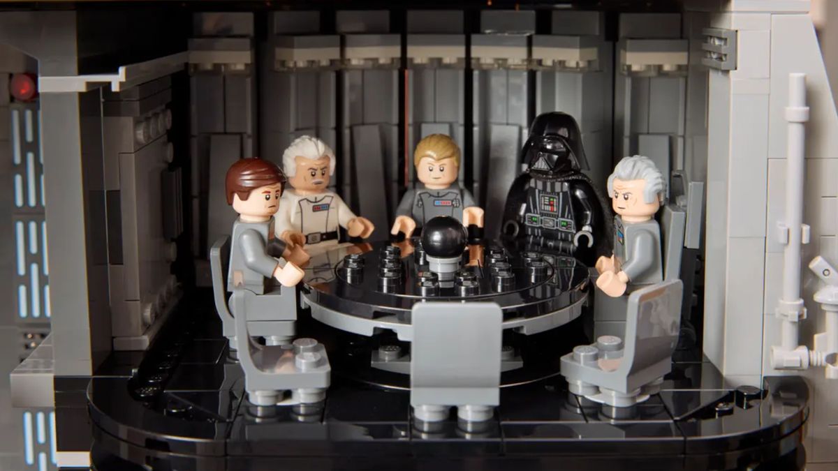 A group of Imperial minifigures and Darth Vader sat around a large black table
