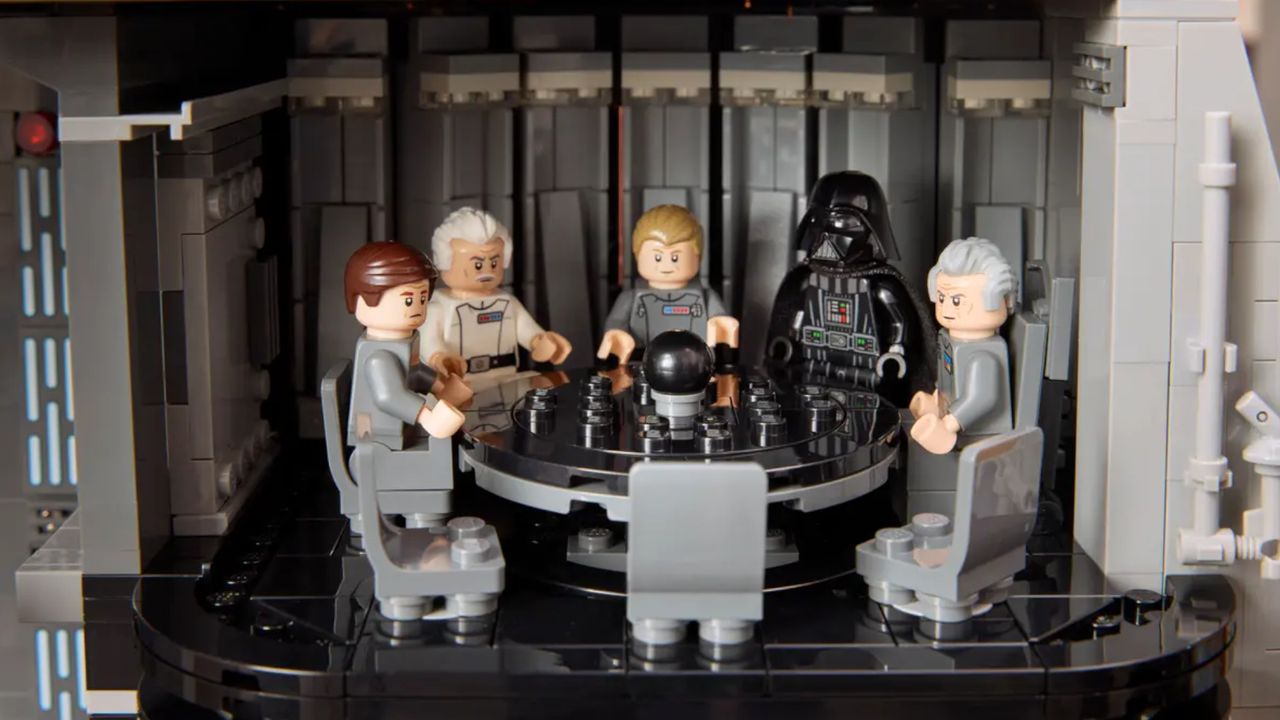 A group of Imperial minifigures and Darth Vader sat around a large black table