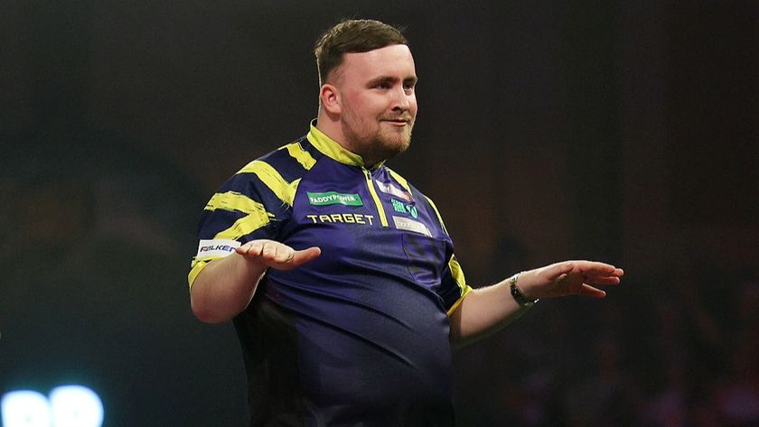 Luke Littler puts his arms out like a surfer dude after winning in Round 1 of the PDC World Darts Championship 2026.