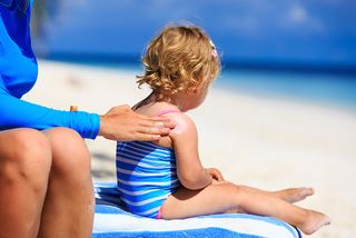 Little girl with sunscreen