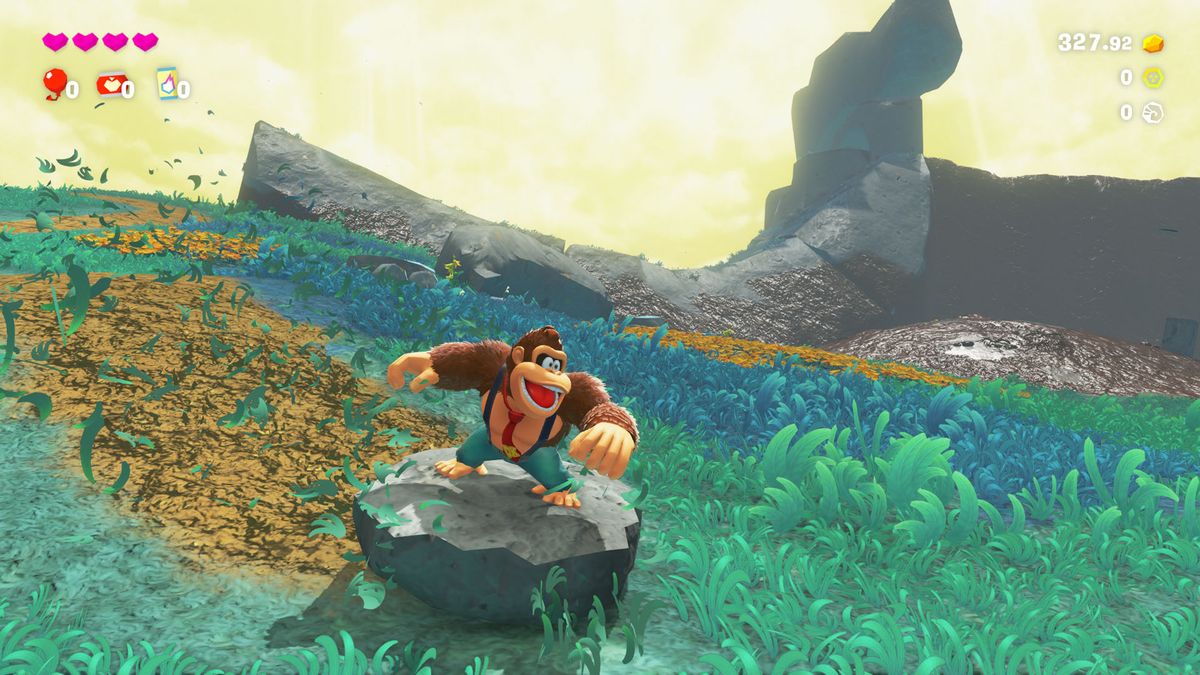 Donkey Kong slides down a hill in Donkey Kong Bananza on a rock, leaving a trail of muddy destruction behind him