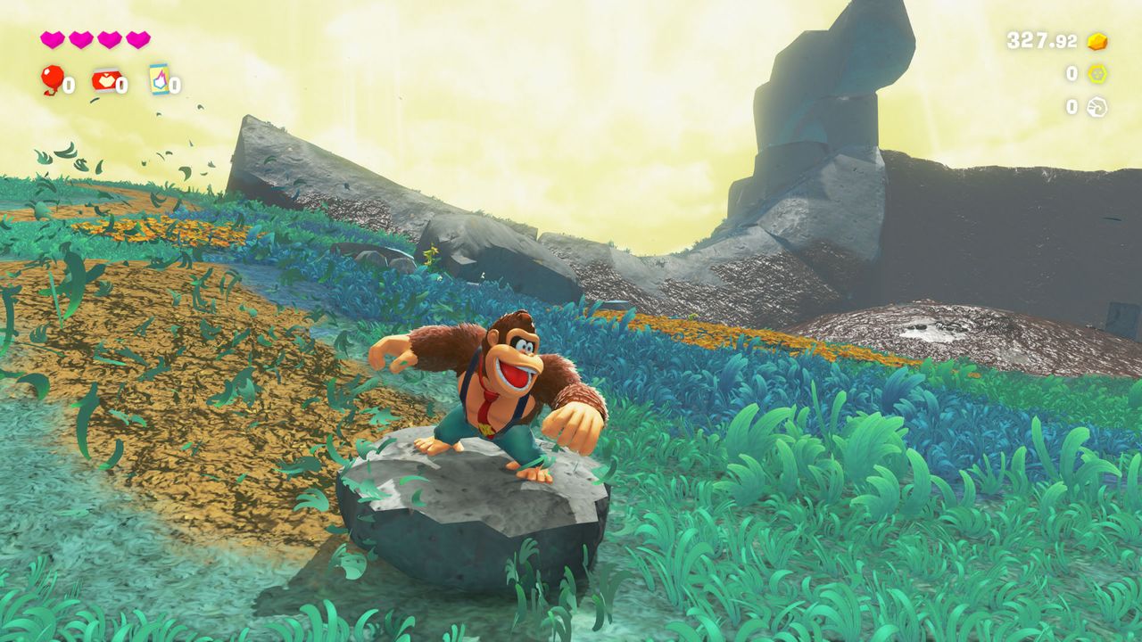 Donkey Kong slides down a hill in Donkey Kong Bananza on a rock, leaving a trail of muddy destruction behind him