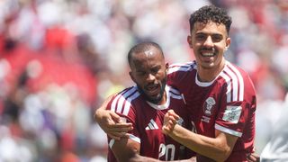 Qatar players Ahmed Fathy and Ayoub Aloui celebrate their draw against Switzerland at the World Cup