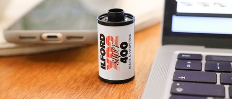 Ilford XP2 Super 35mm film canister on a wooden surface