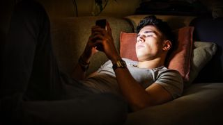 Man using phone irresponsibly at night