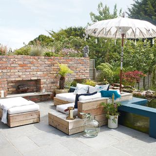 patio area with sofa and umbrella