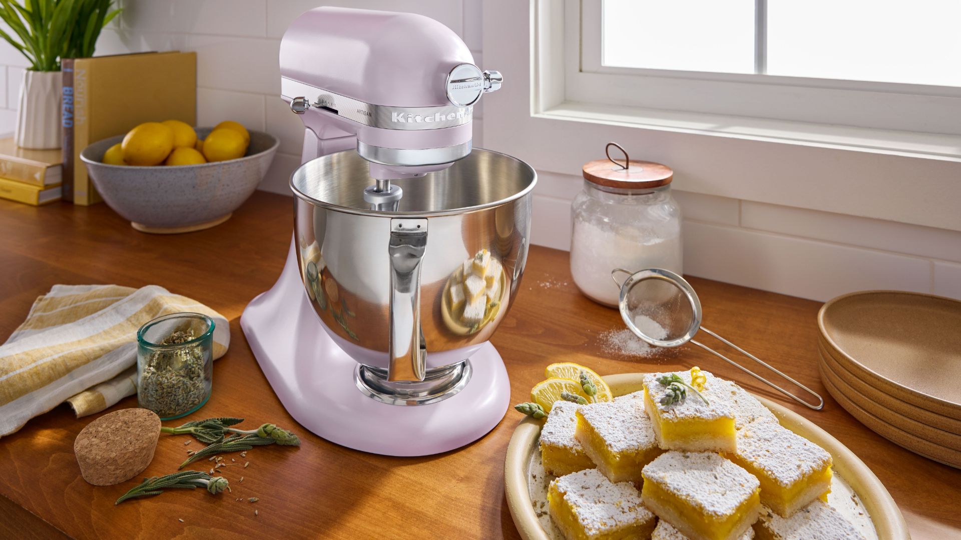 KitchenAid Wildflower Artisan 4.7L Stand Mixer on a counter with a traybake