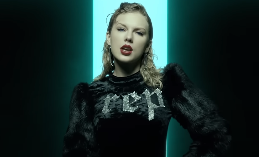 Taylor Swift wearing a sweater that says &quot;rep&quot; in the Look What You Made Me Do music video.