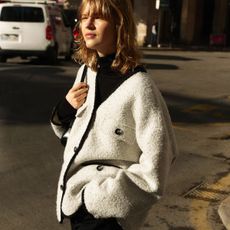 Woman wears boucle tweed jacket