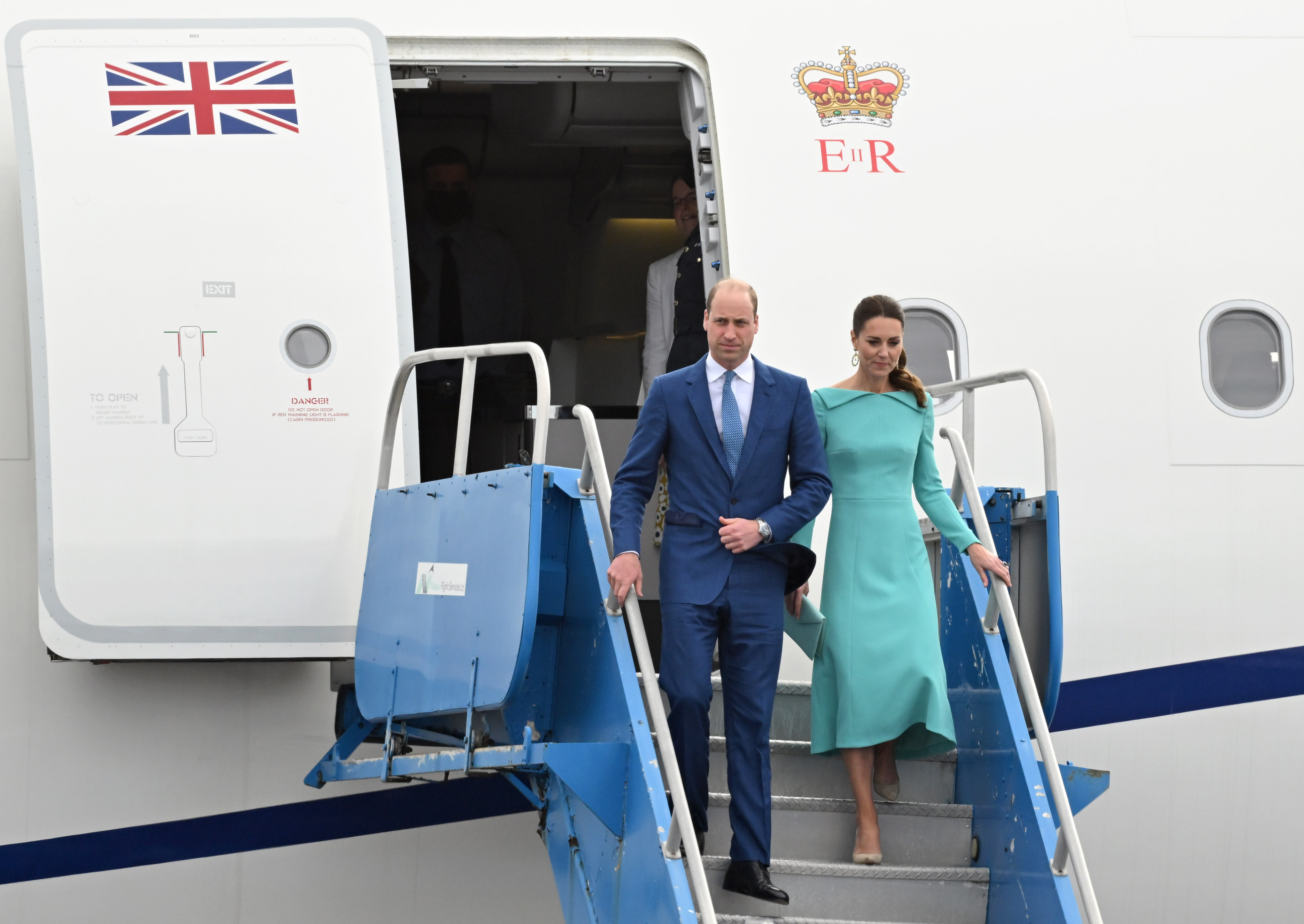 Prince William and Princess Kate walking off a plane down the stairs