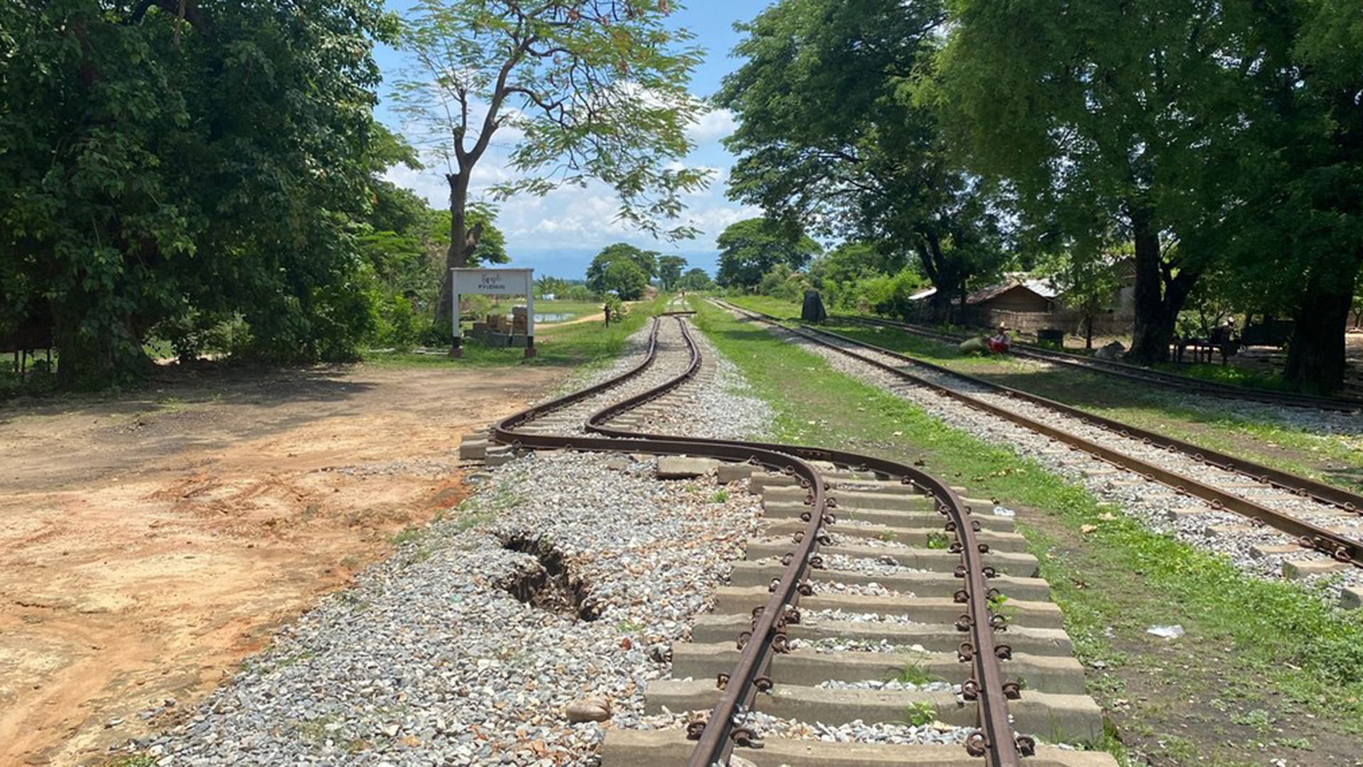 A view of metal railroad tracks curving due to the damage from an earthquake