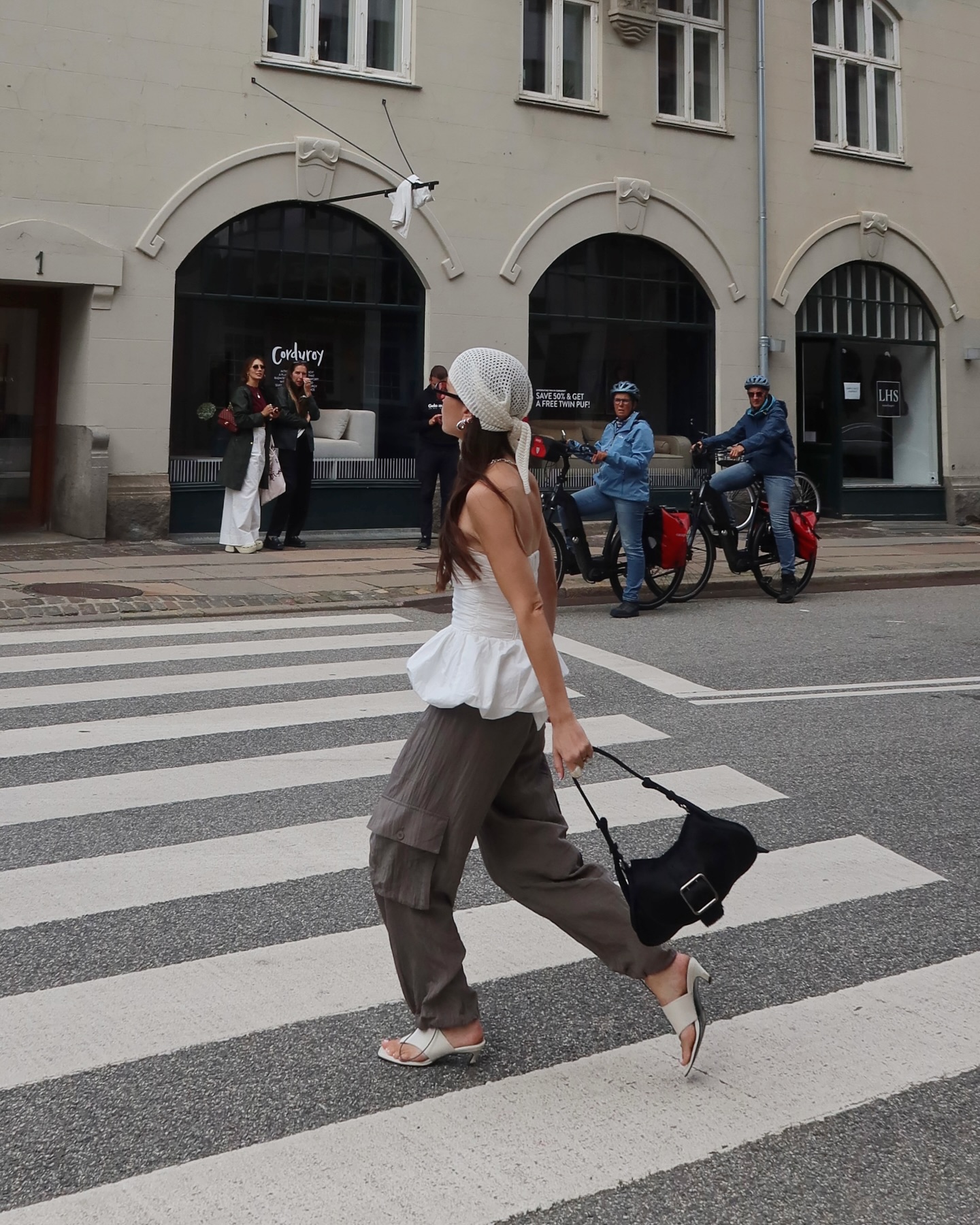 The Alice Edit wears a peplum top, cargo trousers and white sandals