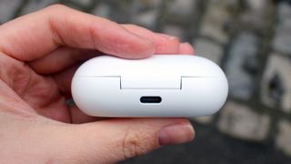 A close up of someone holding the Samsung Galaxy Buds case
